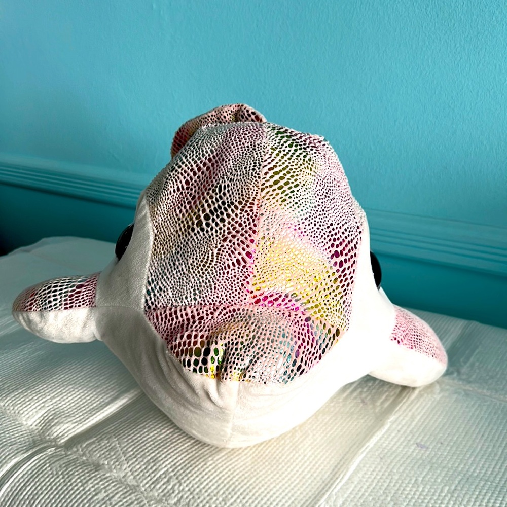 I am selling a cute dolphin, plushy toy with a shiny fins and back fin and tail